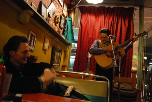 Al Mader listening to Petunia at Slickity Jim's first location, since destroyed by Fire. Photo by Femke van Delft.